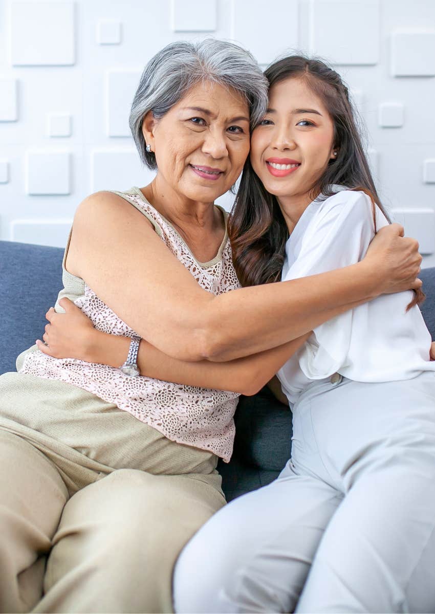 Boomer mom with irrational expectations hugging her adult daughter 