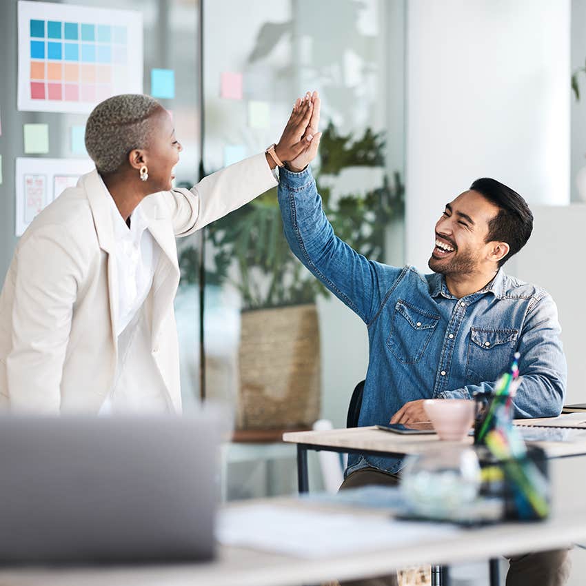 two business people high fiving, positive feedback