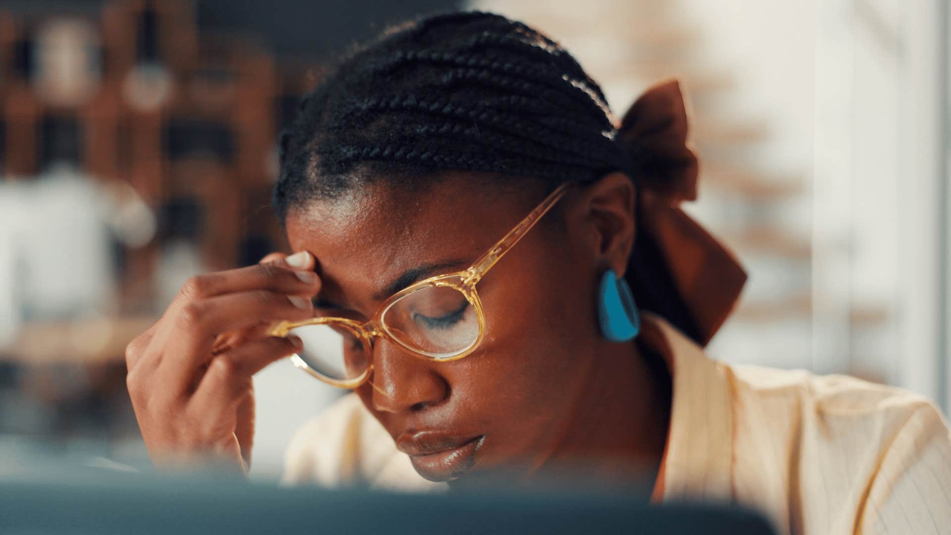 stressed woman sitting in discomfort at work