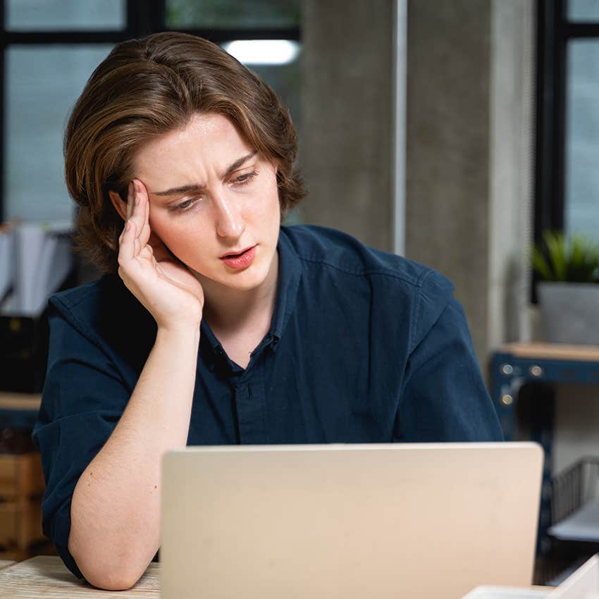 woman massaging scalp while stressed