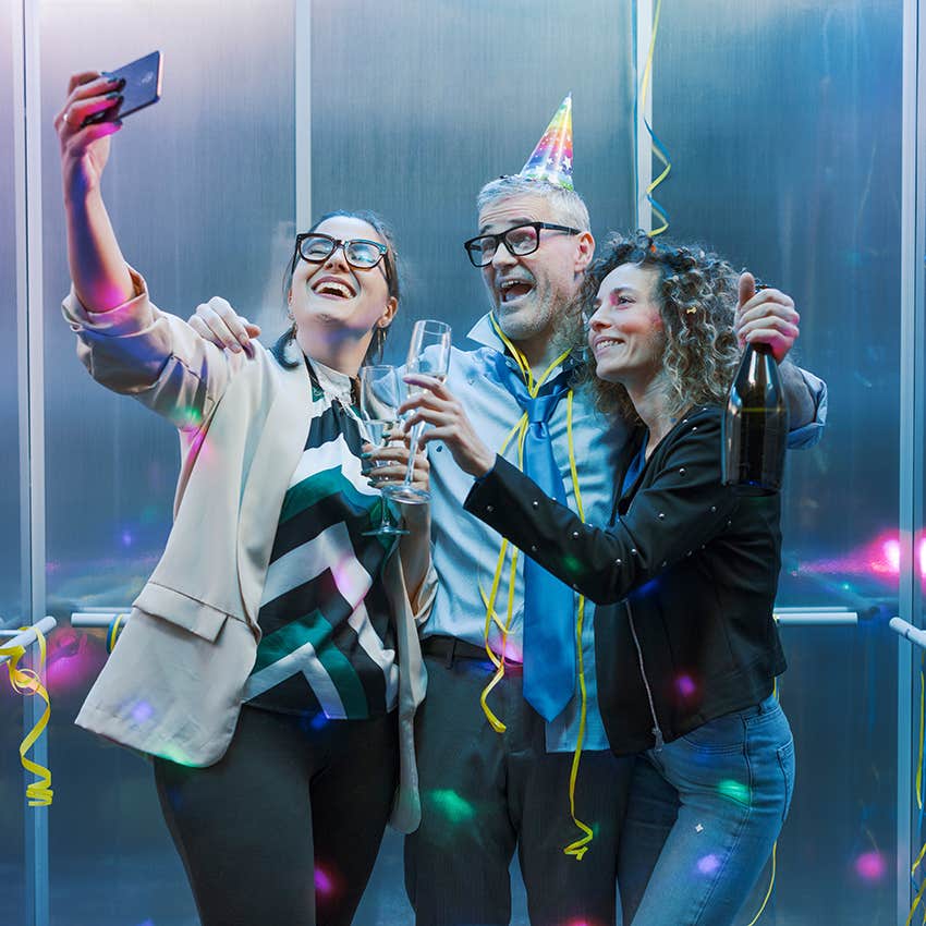 woman taking selfie at birthday party with friends