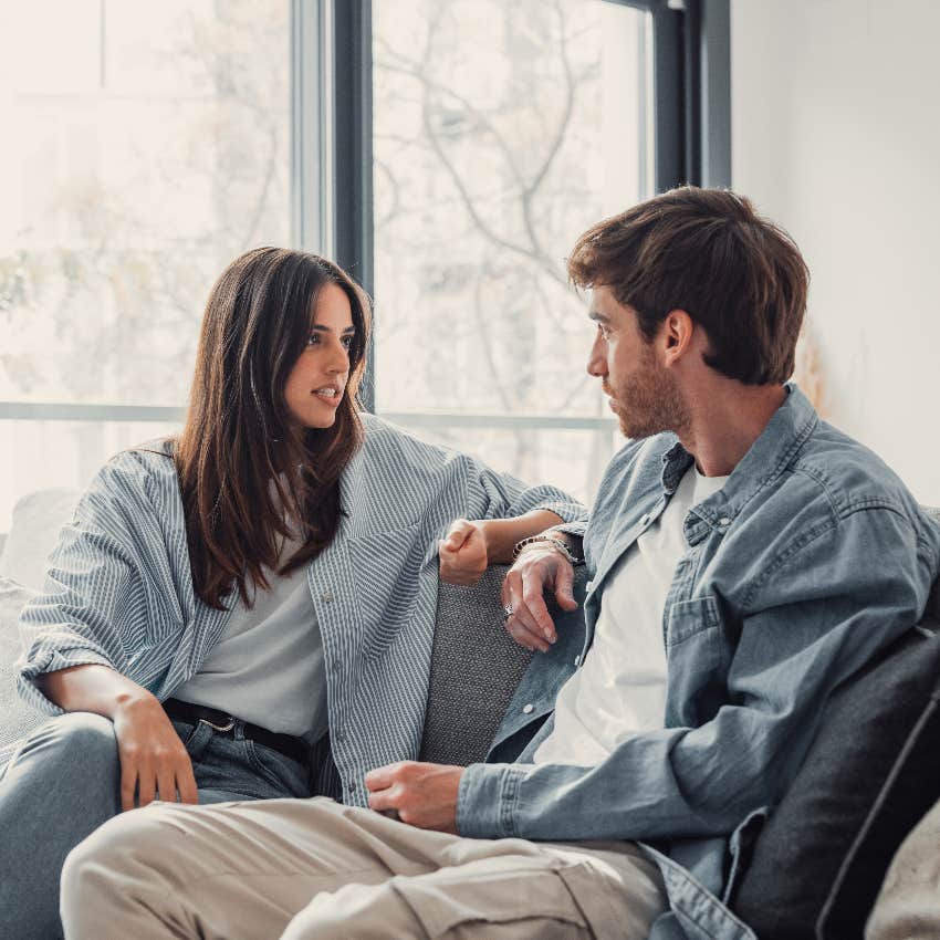 incompatible couple having serious discussion on couch