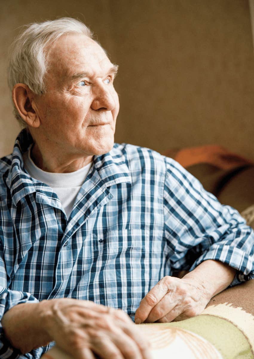 content retired older man looking out of a window
