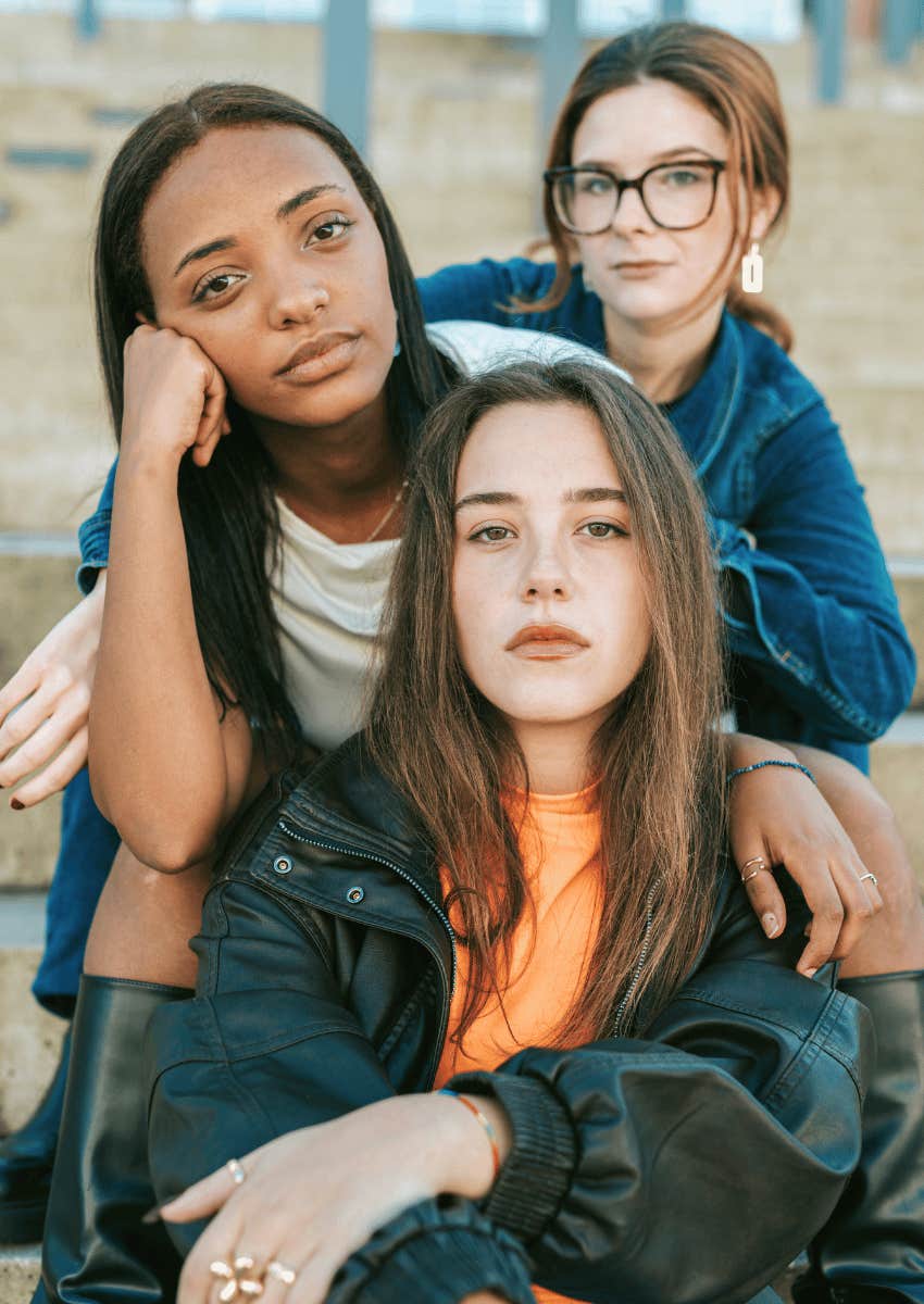 defiant young women sitting together