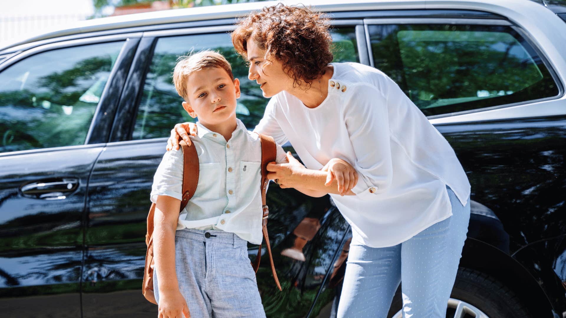 mom gaslighting young boy dropping him off at school