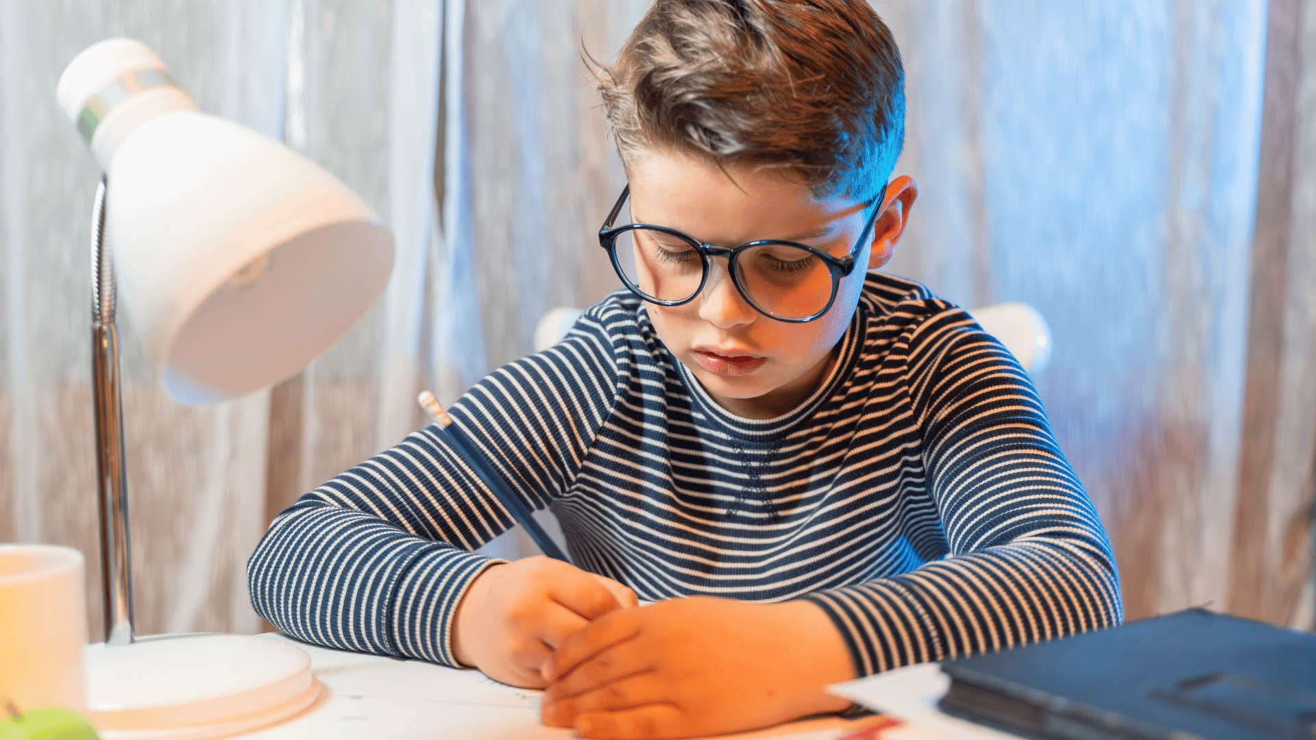 gifted child studying hard at home feeling lonely
