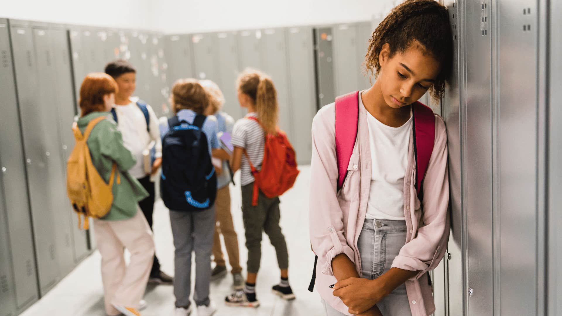 young girl being rejected and left out by kids at school