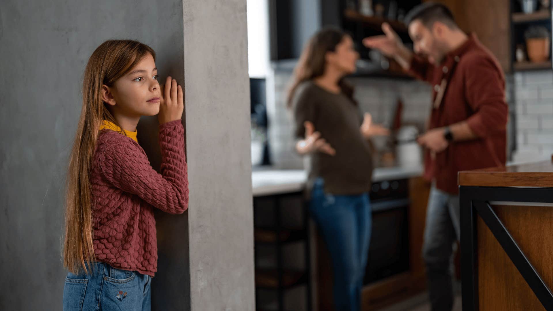 little girl listening to parents argue about getting divorced