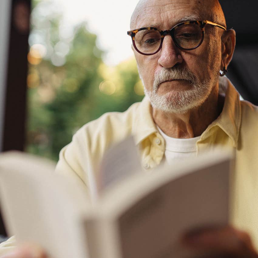 older man reading to keep his brain healthy