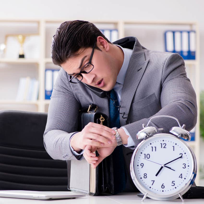 man looking at a watch and a clock because he is too busy