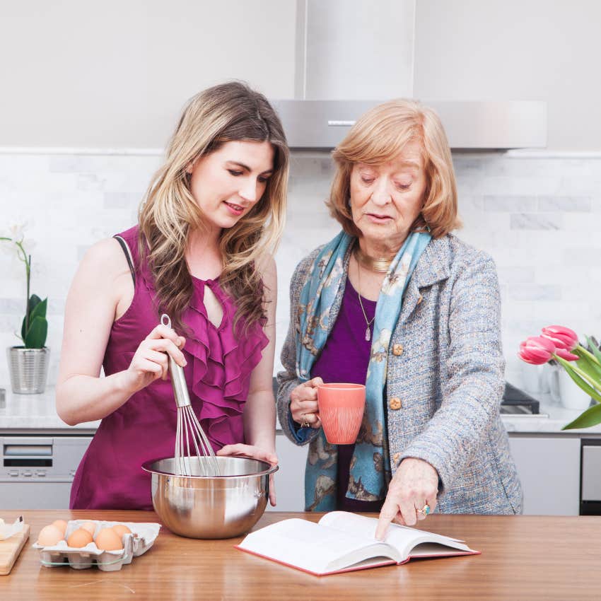 emotionally intelligent woman learning to cook from an elderly woman