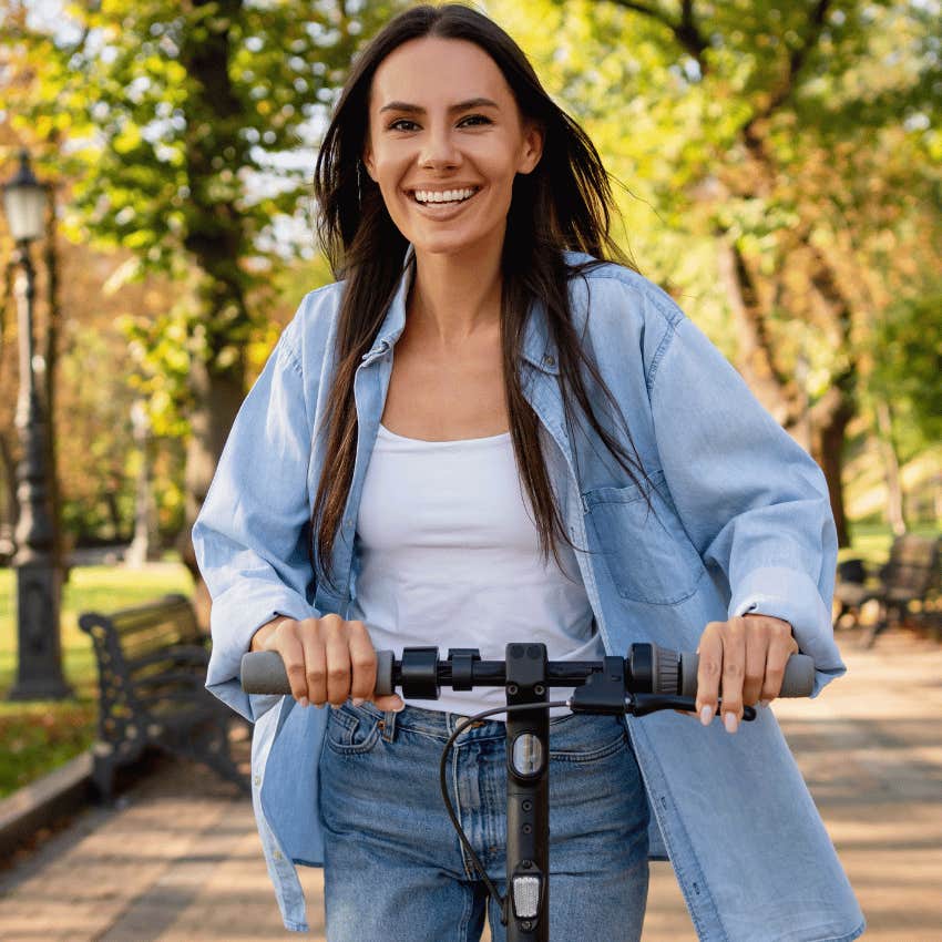 emotionally strong woman riding a scooter outside