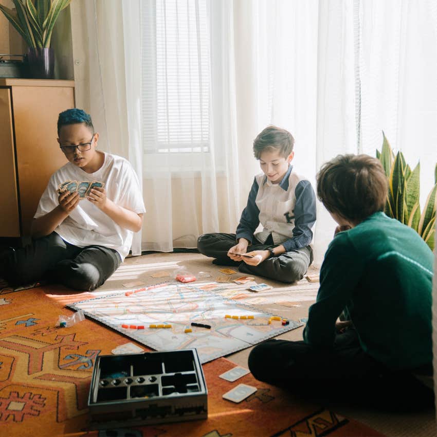 Kids playing a board game while enjoying free time without using any electronic devices