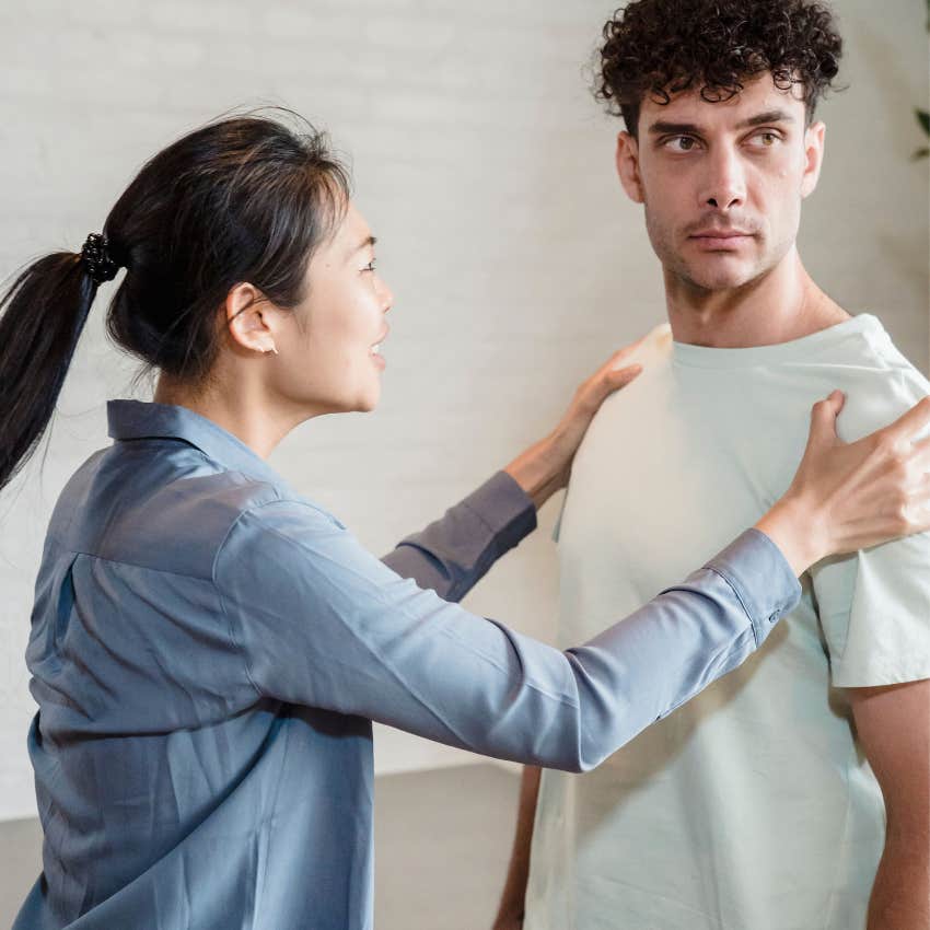 Confident man firmly setting boundaries while woman ignores his personal space and requests
