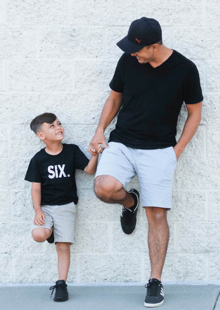 father and son smiling at each other