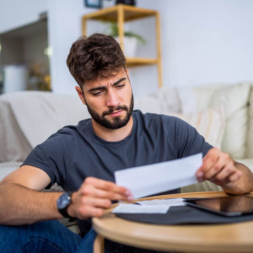 Man with chronically low wages looking at his bill.