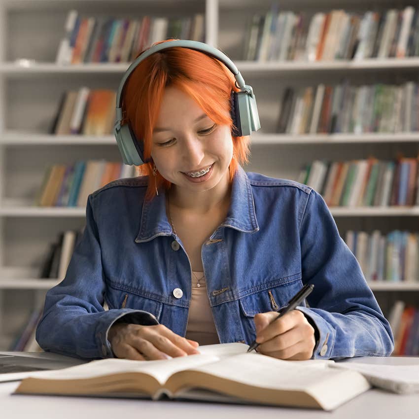 gen z woman smiling while working 