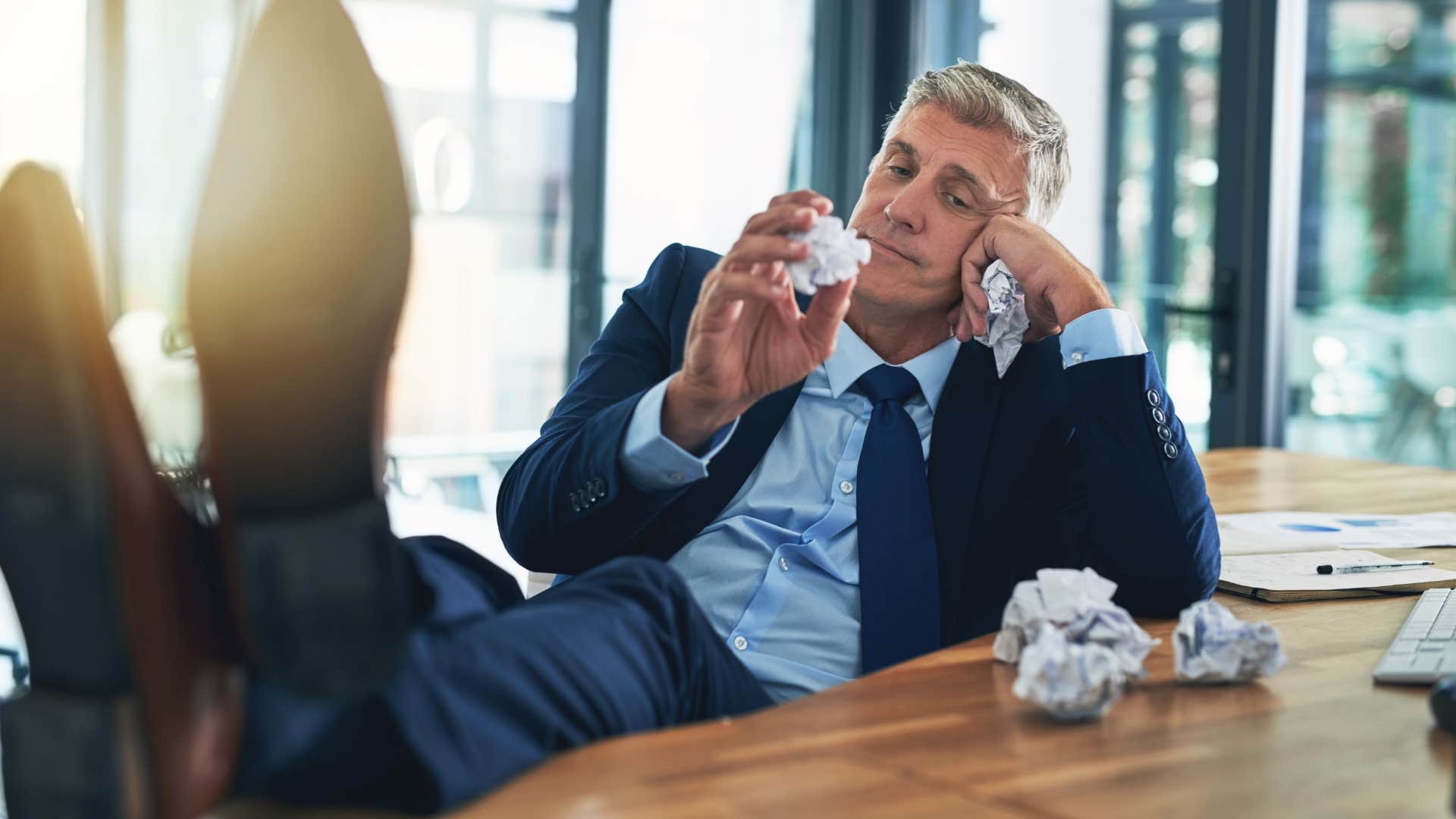 intelligent man procrastinating at work being lazy