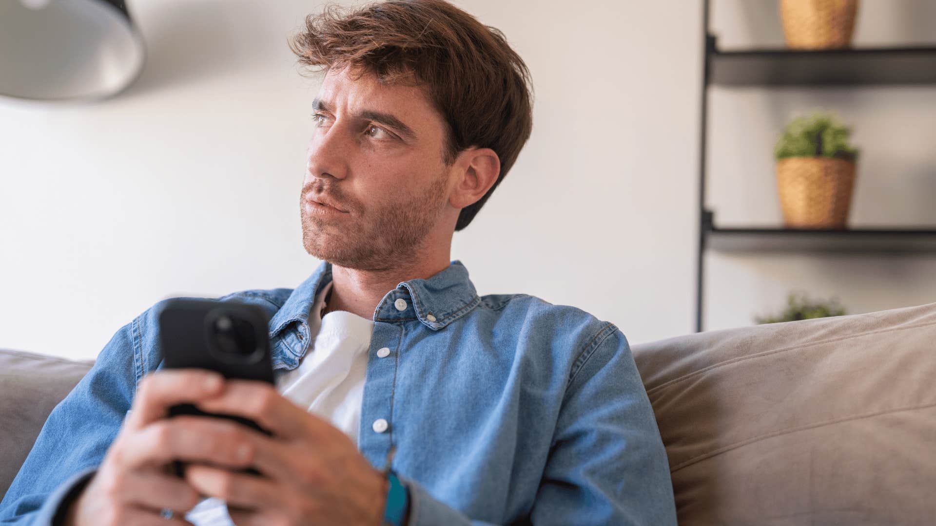 intelligent man on his phone saying no to social plans