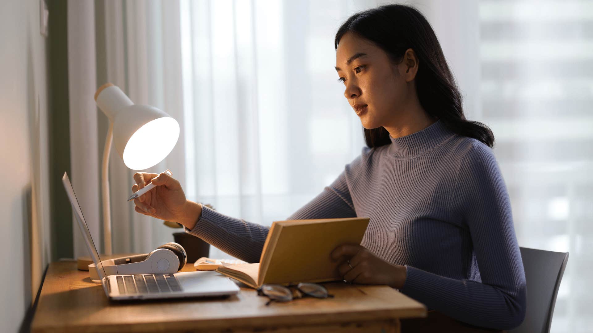 woman with low self-esteem over-preparing at her desk