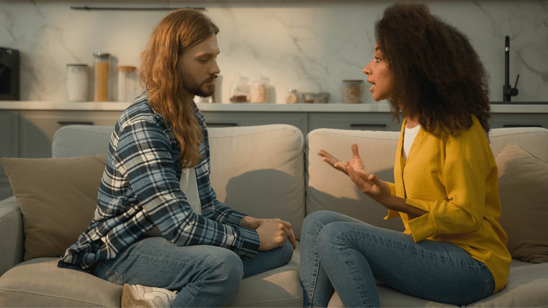 couple in an unhealthy relationship arguing on the couch