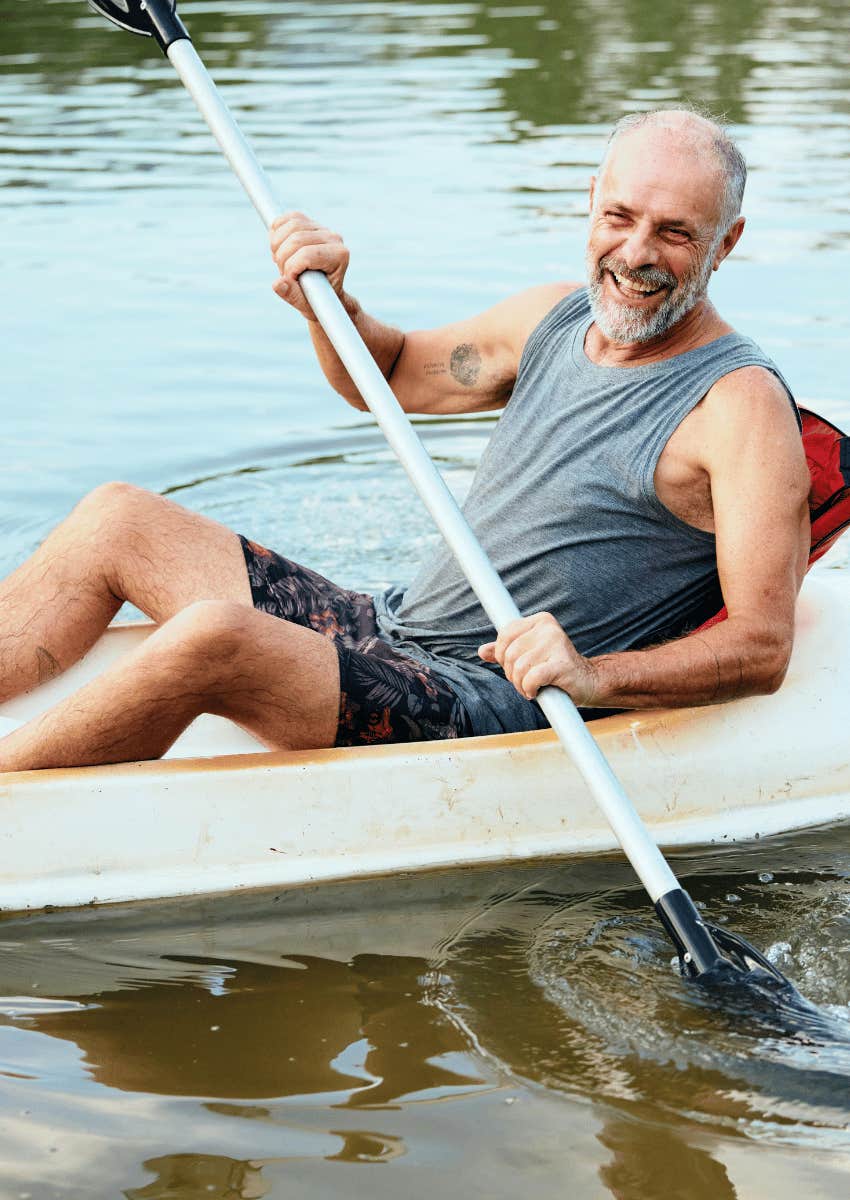 happy older man kayaking in his retirement