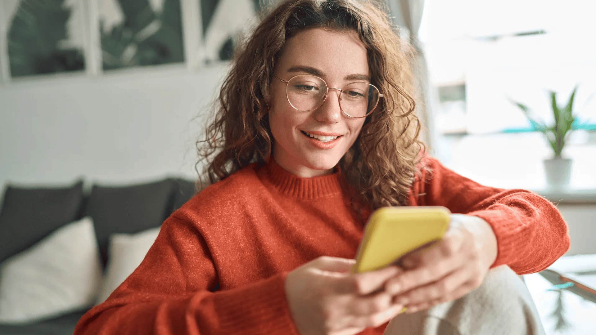 young woman looking at group chat but not responding