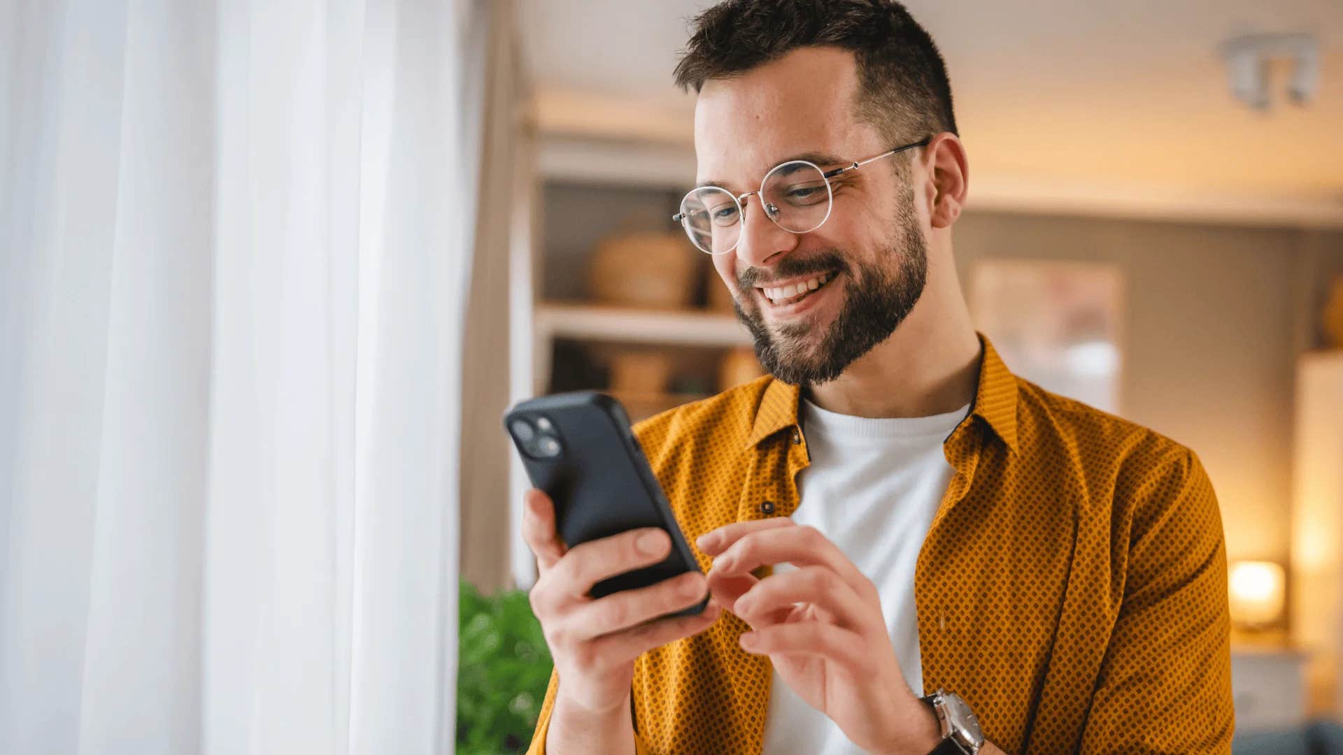 man choosing words carefully in group chats on phone