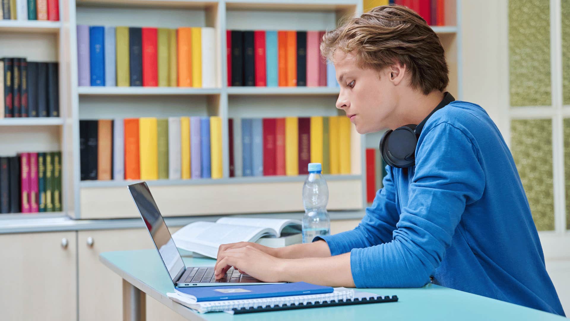 teenage boy on his computer being taught to stay productive