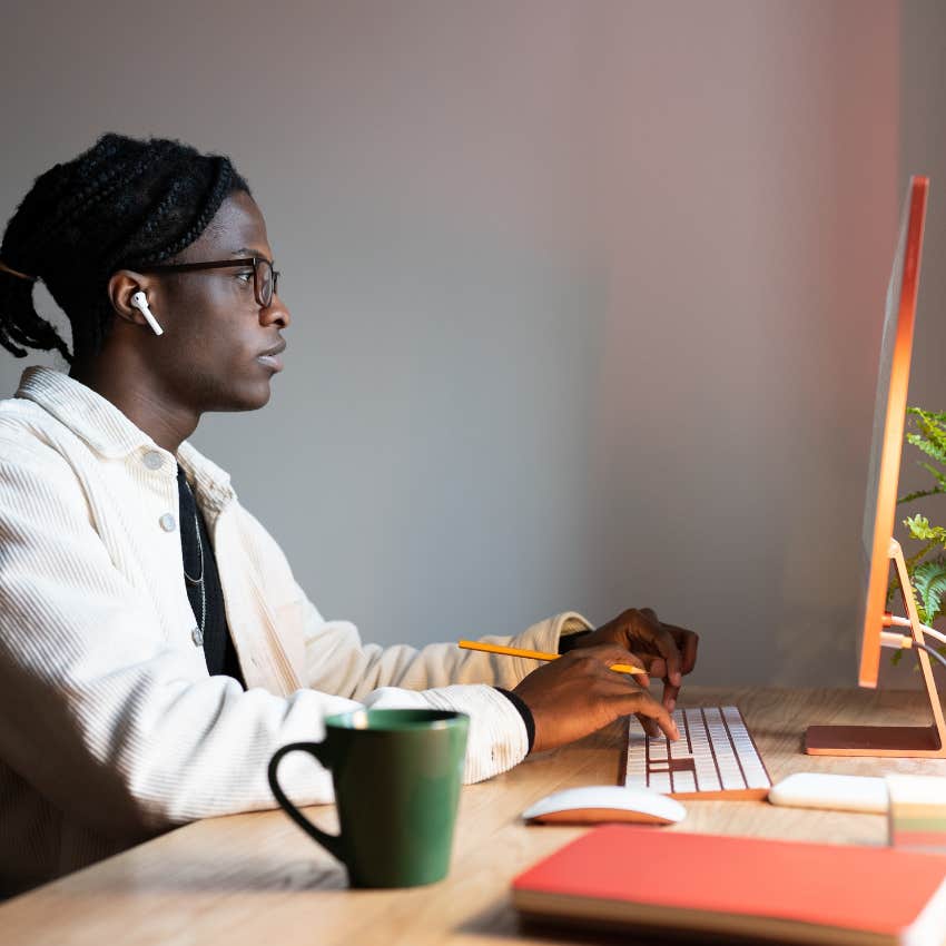 man typing on a computer keyboard