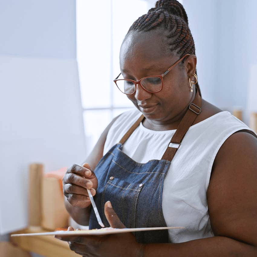 highly intelligent and creative woman painting at home