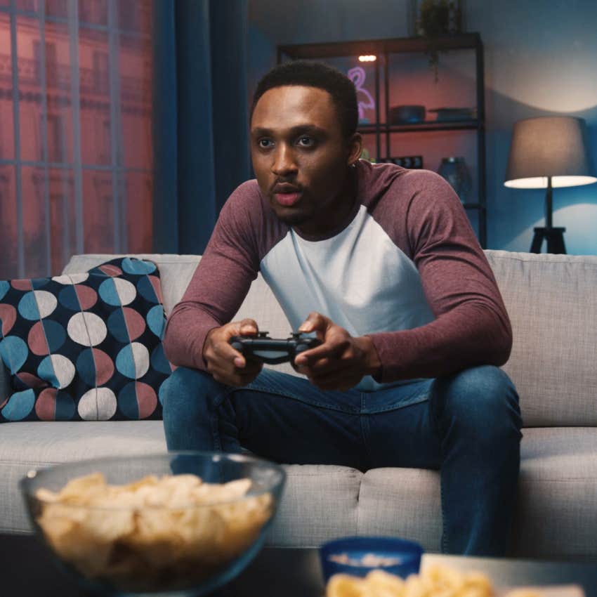 man relaxing by playing video games because he has a job that requires a lot of thinking