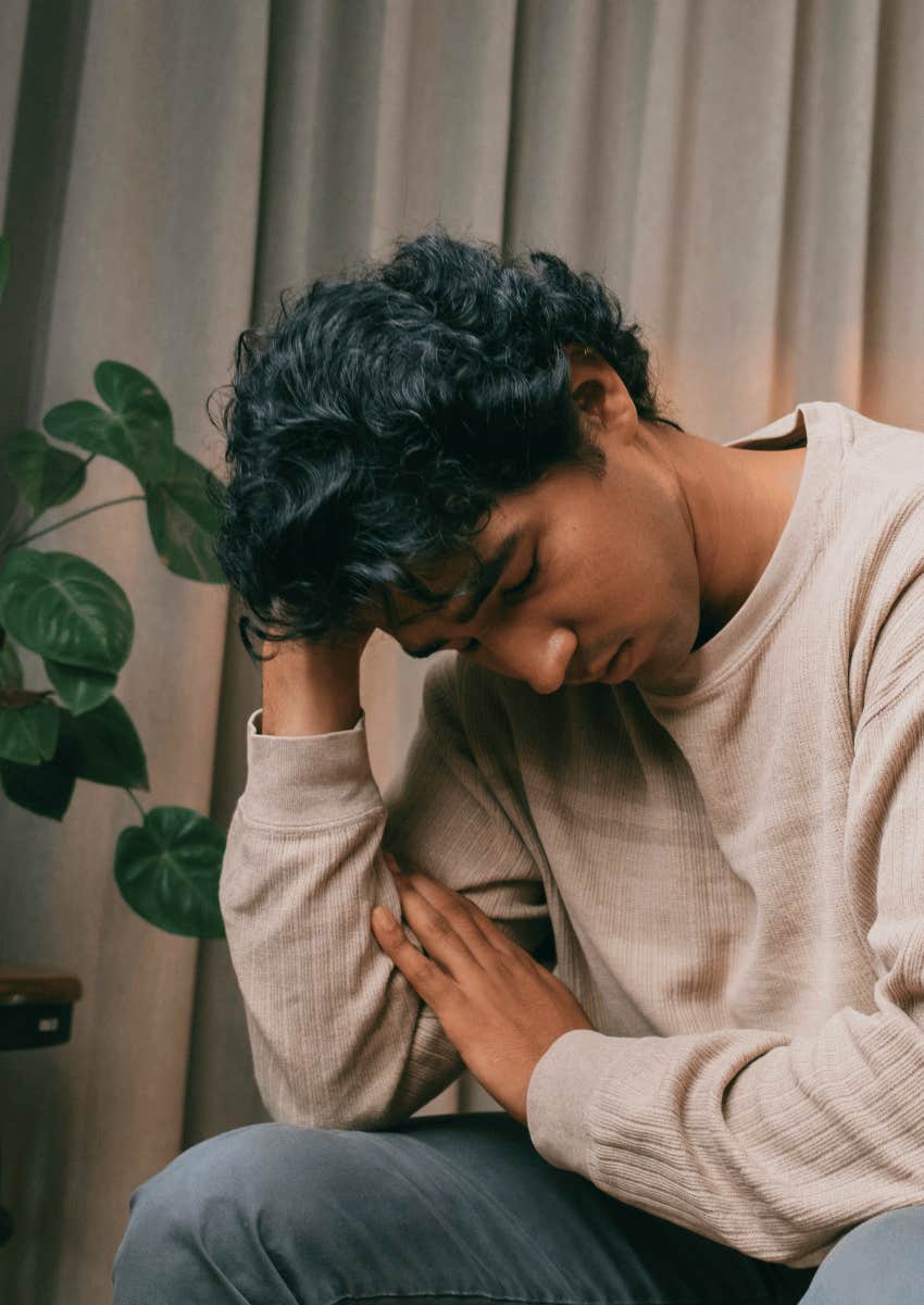 hopeless young man with his head down and eyes closed