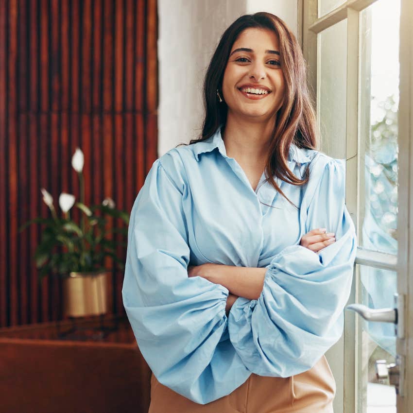 happy woman who sees the good in everyone smiling