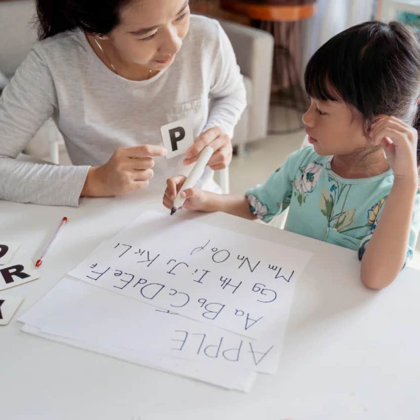little girl learning alphabet with different song