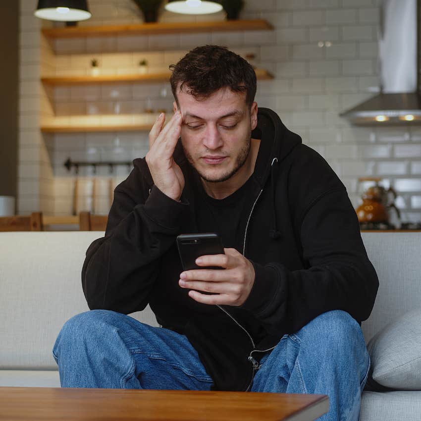 man suffering from media overload and overstimulation looking at phone