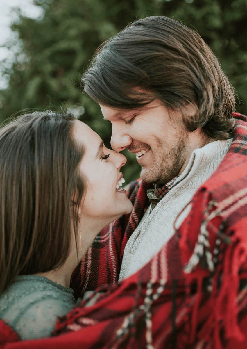 loving couple wrapped in a blanket together