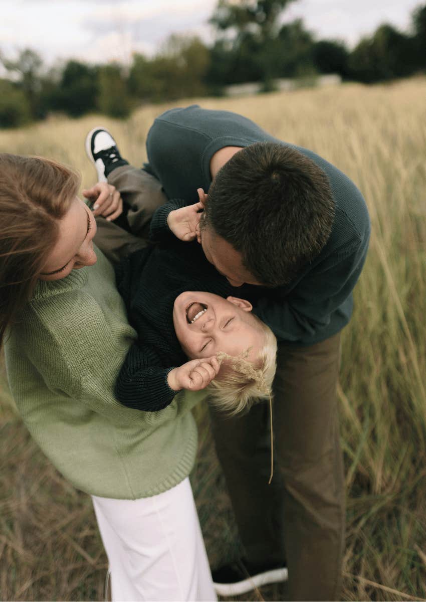 loving family holding laughing child