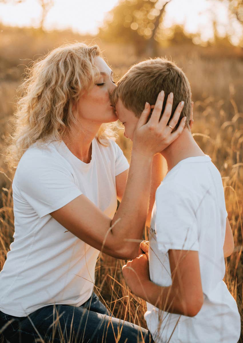 loving mom kissing her son's forehead