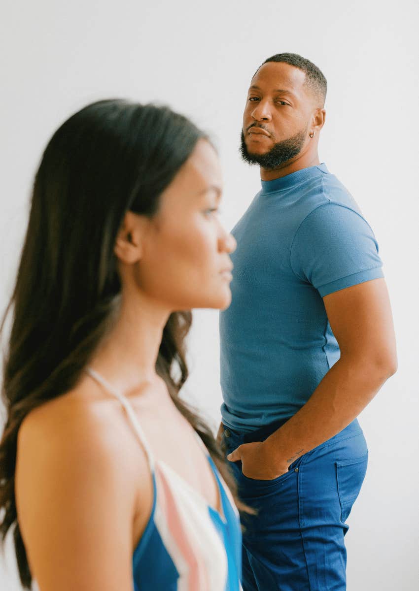 cheater man staring down at woman