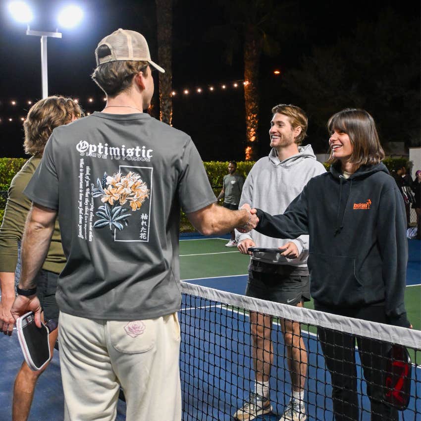 Man smiling and congratulating a competitor after losing a friendly competition