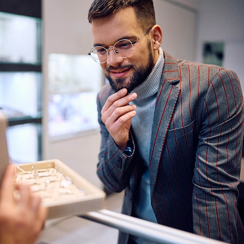 man picking out jewelry for his girlfriend