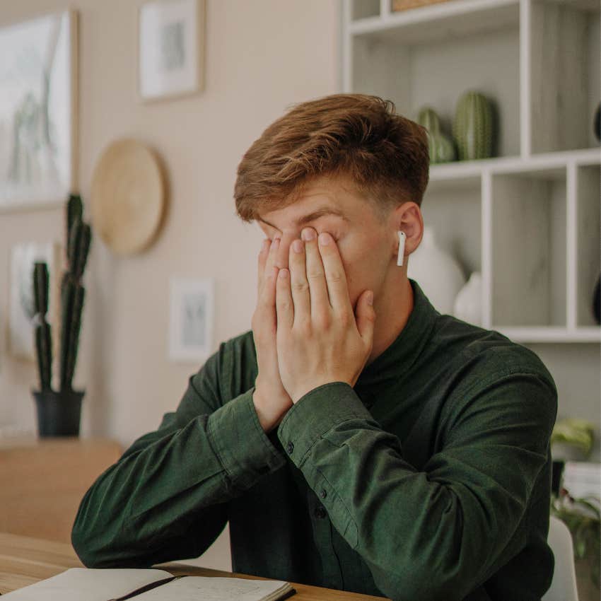 Man pretending to be happy rubs eyes saying i'm just tired