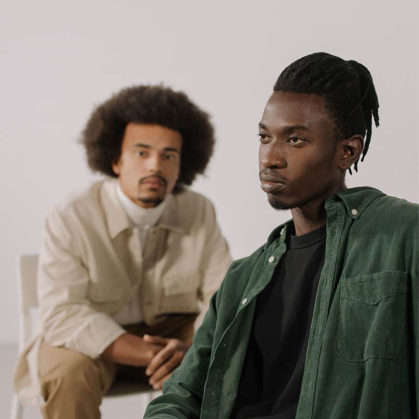 Man shutting down a conversation while his friend looks disappointed and unheard