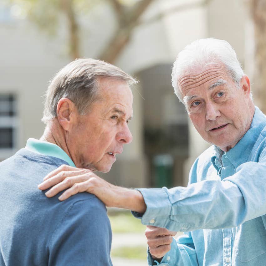 lying man holding his friend's shoulder saying i would never do that
