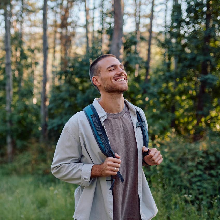happy man walking outside in nature