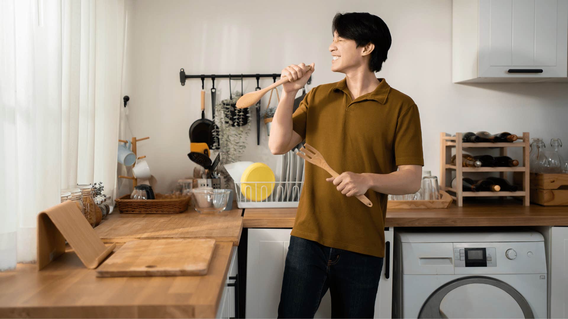 mentally strong man singing in the kitchen keeping his autonomy