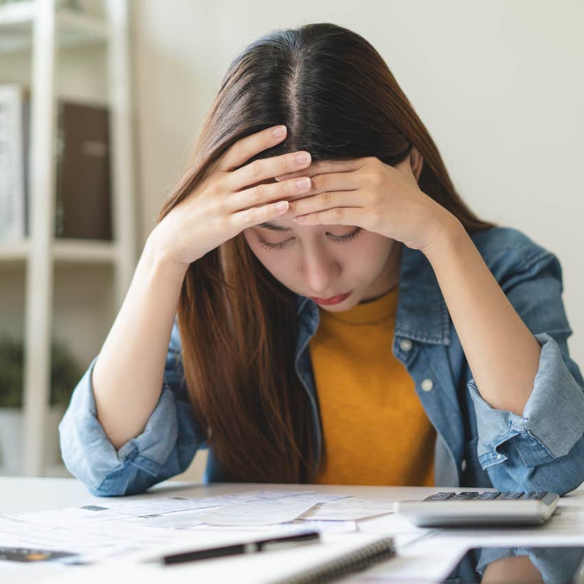 millennial woman worried about paying her bills