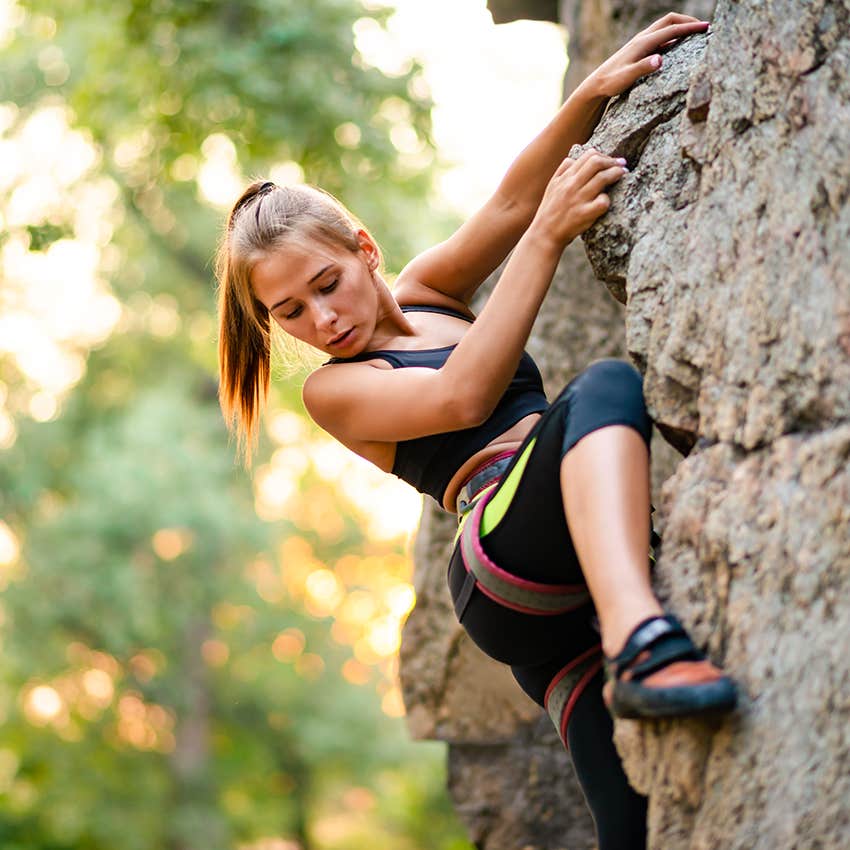 woman taking risk while rock climbing