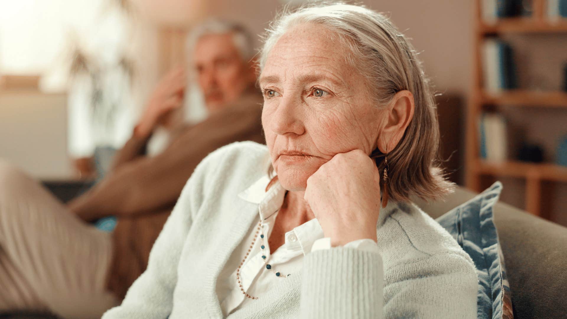older narcissistic woman thinking deeply at home